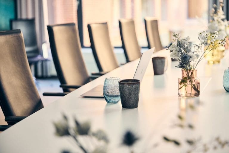 Mødelokale i Odense Congress Center med konferencebord og moderne indretning